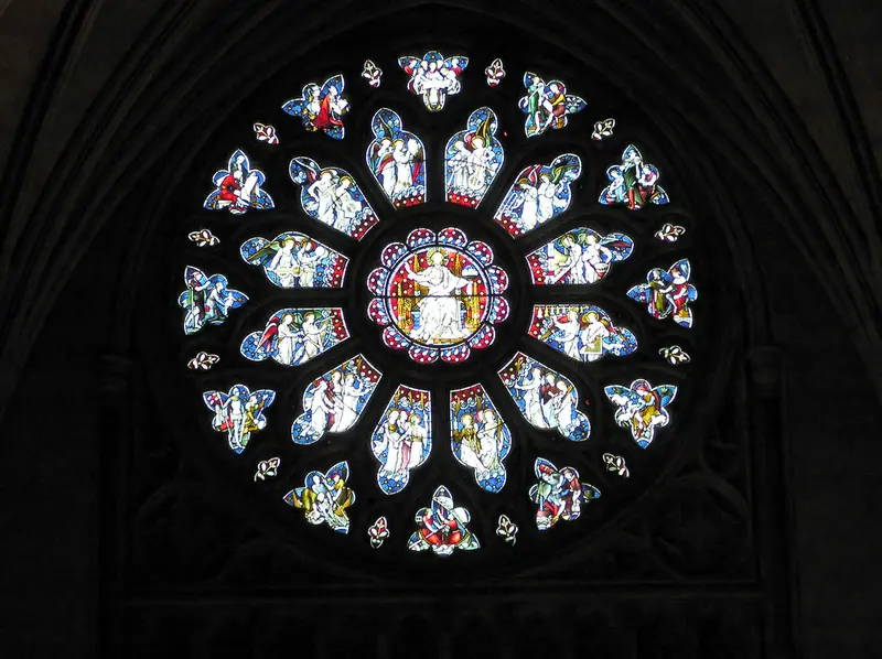 The rose window at the west end of Bristol Cathedral, with figures in pale blue and white glass
