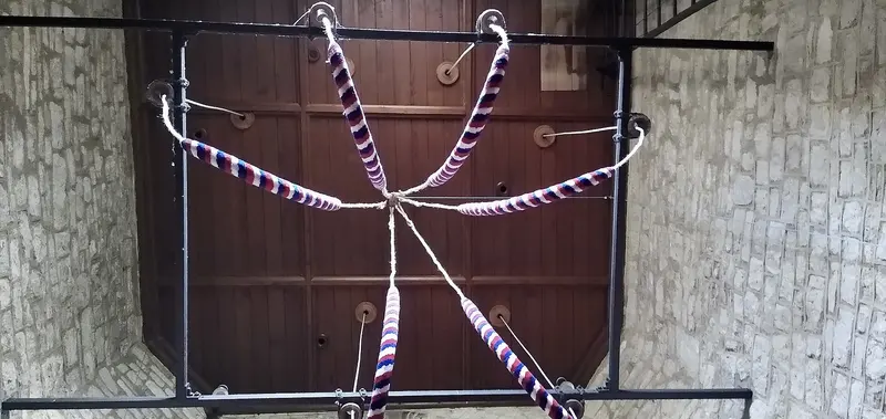 Striped bell ropes looped up inside a church tower